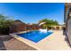 Inviting backyard oasis featuring a sparkling pool, waterfall, and patio at 3702 S Garrison --, Mesa, AZ 85212