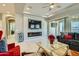 Living room with fireplace, large TV, and sliding glass doors at 4341 E Evelyn St, Gilbert, AZ 85295