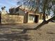Tan stucco condo with tile roof, wooden fence, and a tree in front at 4766 W Rose Ln, Glendale, AZ 85301