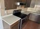 Stainless steel stove and light countertops in kitchen at 4766 W Rose Ln, Glendale, AZ 85301