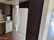 White refrigerator and wood cabinetry in kitchen at 4766 W Rose Ln, Glendale, AZ 85301