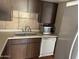 Galley kitchen with wood cabinets and appliances at 4766 W Rose Ln, Glendale, AZ 85301