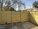 Yellow wooden fence surrounds a small patio area at 4766 W Rose Ln, Glendale, AZ 85301