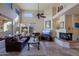 Spacious living room with fireplace and large windows at 6934 E Bramble Berry Ln, Scottsdale, AZ 85266