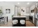 Modern kitchen with island, gray cabinets, and white backsplash at 7504 S 75Th Dr, Laveen, AZ 85339