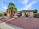 Landscaped front yard with a large palm tree and gravel at 8915 W Rosemonte Dr, Peoria, AZ 85382