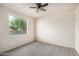 Bedroom with tile floors, ceiling fan, and window with natural light at 9307 W Jefferson St, Tolleson, AZ 85353