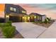 Two-story home with dark gray exterior, two-car garage, and landscaped front yard at 11054 E Utopia Ave, Mesa, AZ 85212