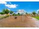 Community playground with tire swing at 11054 E Utopia Ave, Mesa, AZ 85212