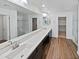 Elegant bathroom with double vanity, large mirror, and walk-in shower at 12010 W Polk St, Avondale, AZ 85323