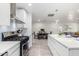 Modern kitchen with gas range and white cabinetry at 1322 E Colter St, Phoenix, AZ 85014