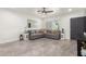 Spacious living room featuring a gray sectional, wood-look floors, and a ceiling fan at 1322 E Colter St, Phoenix, AZ 85014