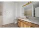 Bathroom with walk-in tub, tiled walls, and wood vanity at 13525 S Burma Rd, Arizona City, AZ 85123