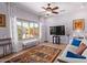 Living room with large window offering natural light and backyard view at 15137 W Cactus Ridge Way, Surprise, AZ 85374