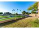 Landscaped front yard with mature trees and green grass at 19124 N 83Rd Ln, Peoria, AZ 85382