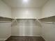 Large walk-in closet with double hanging rods at 1978 E Parr Fame Ln, San Tan Valley, AZ 85140