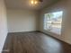 Bright living room featuring large windows and wood-look flooring at 2045 E Birchwood Ave, Mesa, AZ 85204