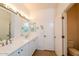 Double vanity bathroom with upgraded light fixtures at 22409 N Los Gatos Dr, Sun City West, AZ 85375