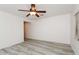 Spacious bedroom with ceiling fan and wood-look flooring at 22409 N Los Gatos Dr, Sun City West, AZ 85375