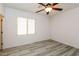 Bedroom with ceiling fan and wood-look flooring at 22409 N Los Gatos Dr, Sun City West, AZ 85375