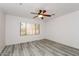 Bright bedroom with ceiling fan and wood-look flooring at 22409 N Los Gatos Dr, Sun City West, AZ 85375