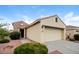Front view of a tan house with stone accents and a two-car garage at 22409 N Los Gatos Dr, Sun City West, AZ 85375