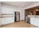 White kitchen cabinets, stainless steel refrigerator, and tile floor at 22409 N Los Gatos Dr, Sun City West, AZ 85375