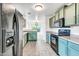 Kitchen with green cabinets, black appliances, and tile floor at 25370 W Jackson Ave, Buckeye, AZ 85326