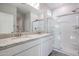 Modern bathroom with double vanity and glass shower at 35595 W Mallorca Ave, Maricopa, AZ 85138