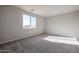 Spacious bedroom with neutral carpeting and large window at 35595 W Mallorca Ave, Maricopa, AZ 85138