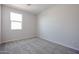 Simple bedroom with grey carpet and a window at 35595 W Mallorca Ave, Maricopa, AZ 85138