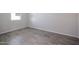 Simple bedroom with grey tile floors and a window at 35595 W Mallorca Ave, Maricopa, AZ 85138