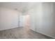 Spacious bedroom with grey tile floors and access to other rooms at 35595 W Mallorca Ave, Maricopa, AZ 85138