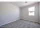 Bright bedroom featuring carpet flooring and a window at 35595 W Mallorca Ave, Maricopa, AZ 85138