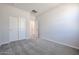 Simple bedroom with carpet flooring and double door closet at 35595 W Mallorca Ave, Maricopa, AZ 85138
