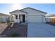 Newly constructed home with two-car garage and desert landscaping at 35595 W Mallorca Ave, Maricopa, AZ 85138