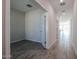 Bright hallway with grey tile floors and access to other rooms at 35595 W Mallorca Ave, Maricopa, AZ 85138