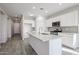 Modern kitchen with island, stainless steel appliances, and granite countertops at 35595 W Mallorca Ave, Maricopa, AZ 85138