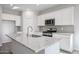 Modern kitchen with island, granite countertops, and stainless steel appliances at 35595 W Mallorca Ave, Maricopa, AZ 85138