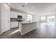 Modern kitchen with island, stainless steel appliances, and granite countertops at 35595 W Mallorca Ave, Maricopa, AZ 85138