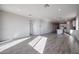 Open floor plan with kitchen island and gray tile floors at 35595 W Mallorca Ave, Maricopa, AZ 85138