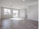 Bright living room with tile floors and sliding glass door to backyard at 35595 W Mallorca Ave, Maricopa, AZ 85138