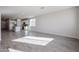 Open concept living and kitchen area with gray tile floors at 35595 W Mallorca Ave, Maricopa, AZ 85138