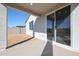 Covered patio with sliding glass door access to home at 35595 W Mallorca Ave, Maricopa, AZ 85138