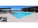 Community pool with a pergola and lounge area at 35595 W Mallorca Ave, Maricopa, AZ 85138