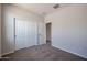 Spacious bedroom with double door closet and carpet flooring at 35605 W Mallorca Ave, Maricopa, AZ 85138