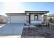 New single-story home with gray exterior, stone accents, and a two-car garage at 35605 W Mallorca Ave, Maricopa, AZ 85138