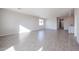 Bright living room with tile floors and views into the kitchen area at 35605 W Mallorca Ave, Maricopa, AZ 85138