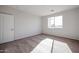 Simple bedroom with carpet flooring and a window at 35625 W Mallorca Ave, Maricopa, AZ 85138