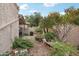 Landscaped backyard with gravel pathway, fire pit, and lush greenery at 4026 E Larkspur Dr, Phoenix, AZ 85032